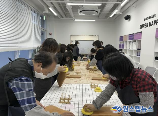 전통시장 제2공영주차장빌딩 1층 홍보관에서 열린 원데이클래스 현장. 참가자들이 목공 도구를 활용해 나무도마를 제작하며 수공예 체험을 즐기고 있다. /사진제공=구리시상권활성화재단